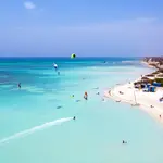 Escape to the beautiful island of Aruba with all-inclusive vacation packages that include airfare. Relax on white sand beaches and enjoy top-notch amenities.