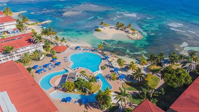 Experience the ultimate family vacation at Holiday Inn Montego Bay, offering all-inclusive bliss, fine dining, and endless activities on a private beach.