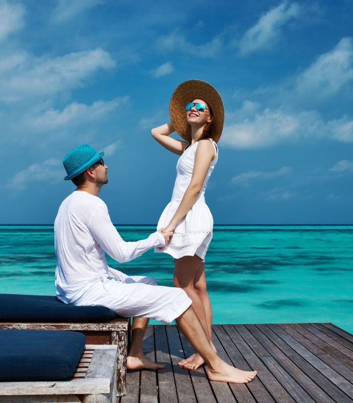 Couple on honeymoon at an all-inclusive resort in the Maldives Couple on honeymoon at an all-inclusive resort in the Maldives